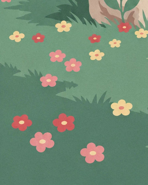 A green meadow dotted with red, pink and yellow flowers at the foot of a rock