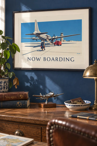 Poster of a propeller airliner and passengers boarding: framed on the wall