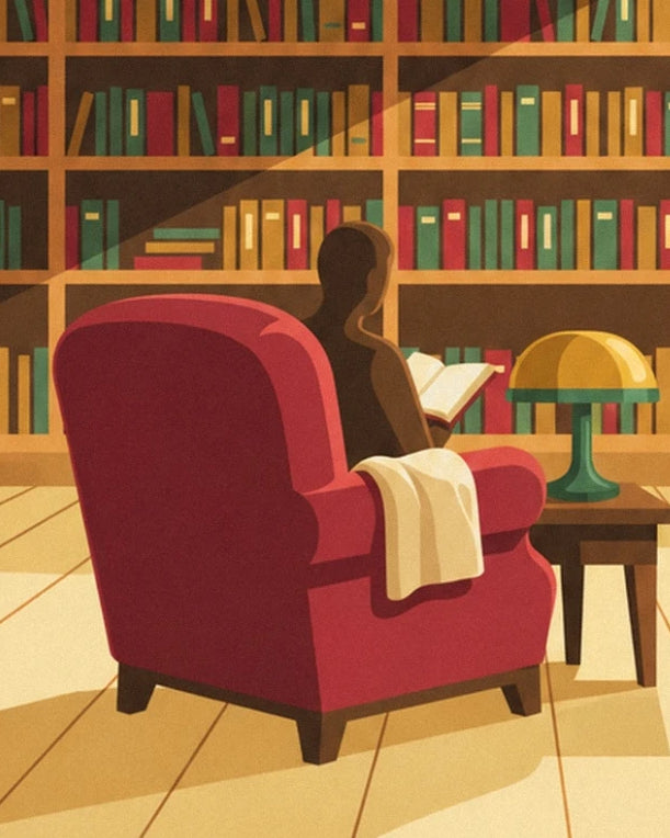 The reader in a red armchair, with an open book, beside a golden lamp