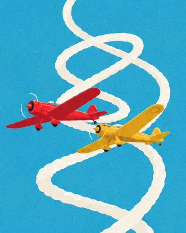 Un avion rouge et un avion jaune qui s'enroulent dans leurs traînées de fumée blanche