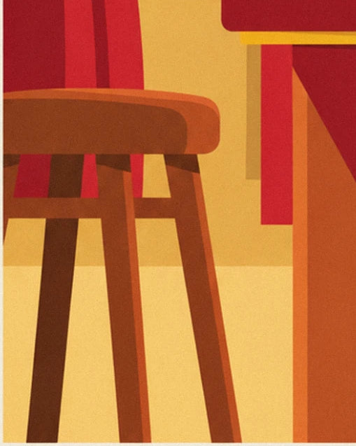 The brown wooden stool in front of the red curtain, in the golden light of the cabaret