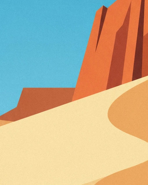 The large orange rock with dark edges, towering over a pale sand dune beneath a blue sky