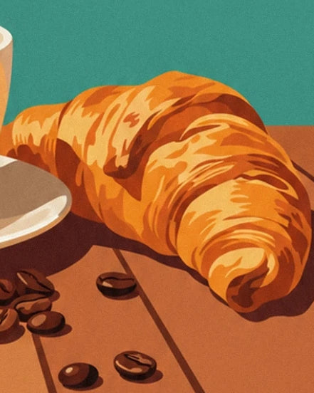 A golden croissant with crisp layers on the wooden table