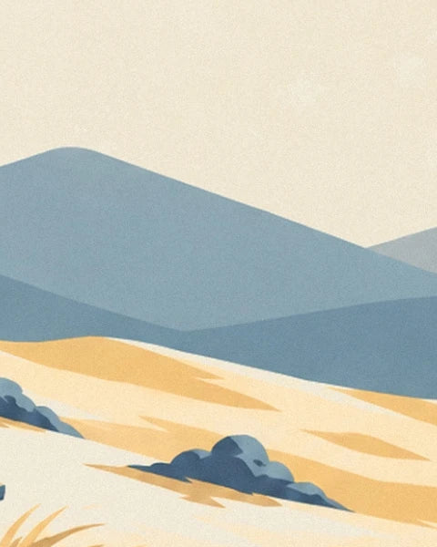 The blue mountains behind a golden slope dotted with rocks