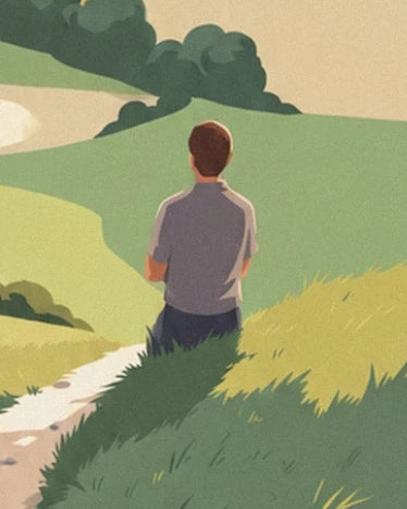 A man seen from behind in a grey shirt, near the path lined with tall grass