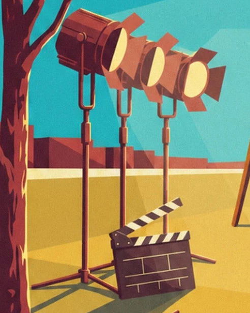 The 3 lights on stands and an open clapperboard on the yellow floor of the film set