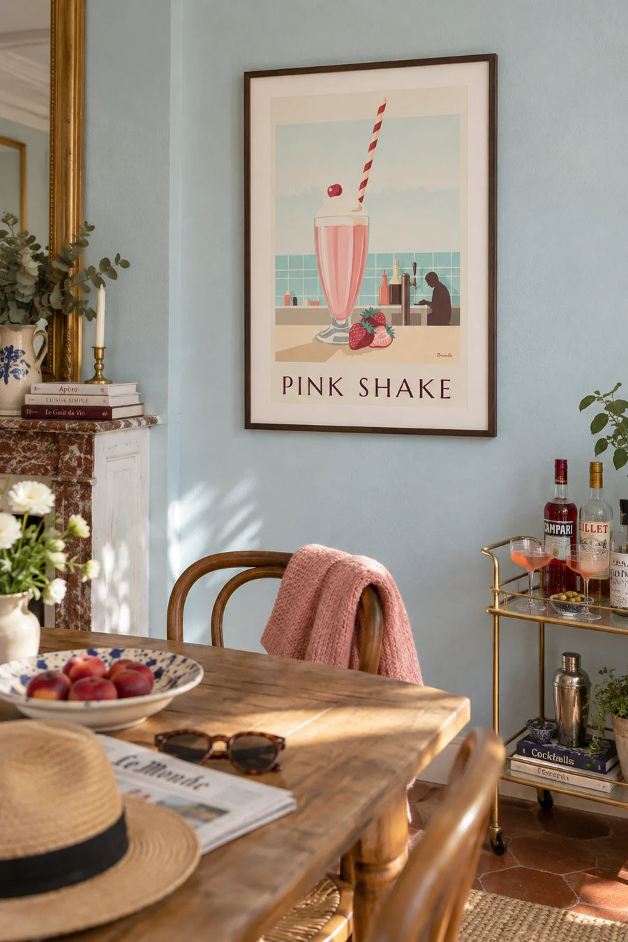 Poster of a strawberry milkshake at a diner counter: framed on the wall
