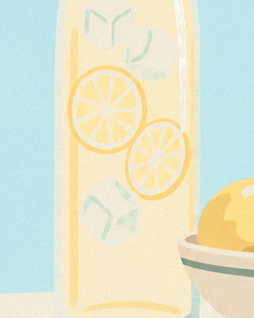 The carafe of pale yellow lemonade with lemon slices and ice cubes