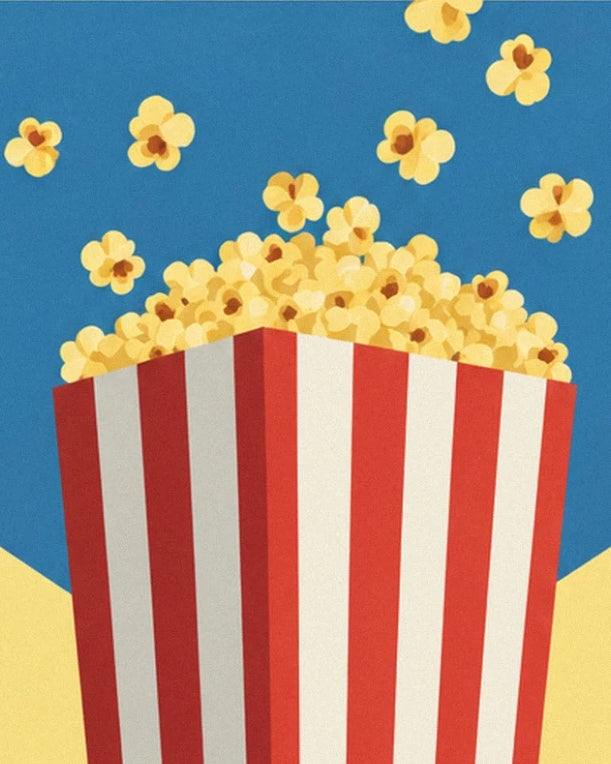 The striped cone overflowing with golden popcorn, with scattered pieces on the blue background