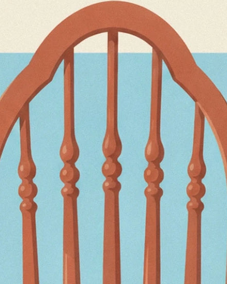 The rounded back of the child's chair with its brown wooden spindles