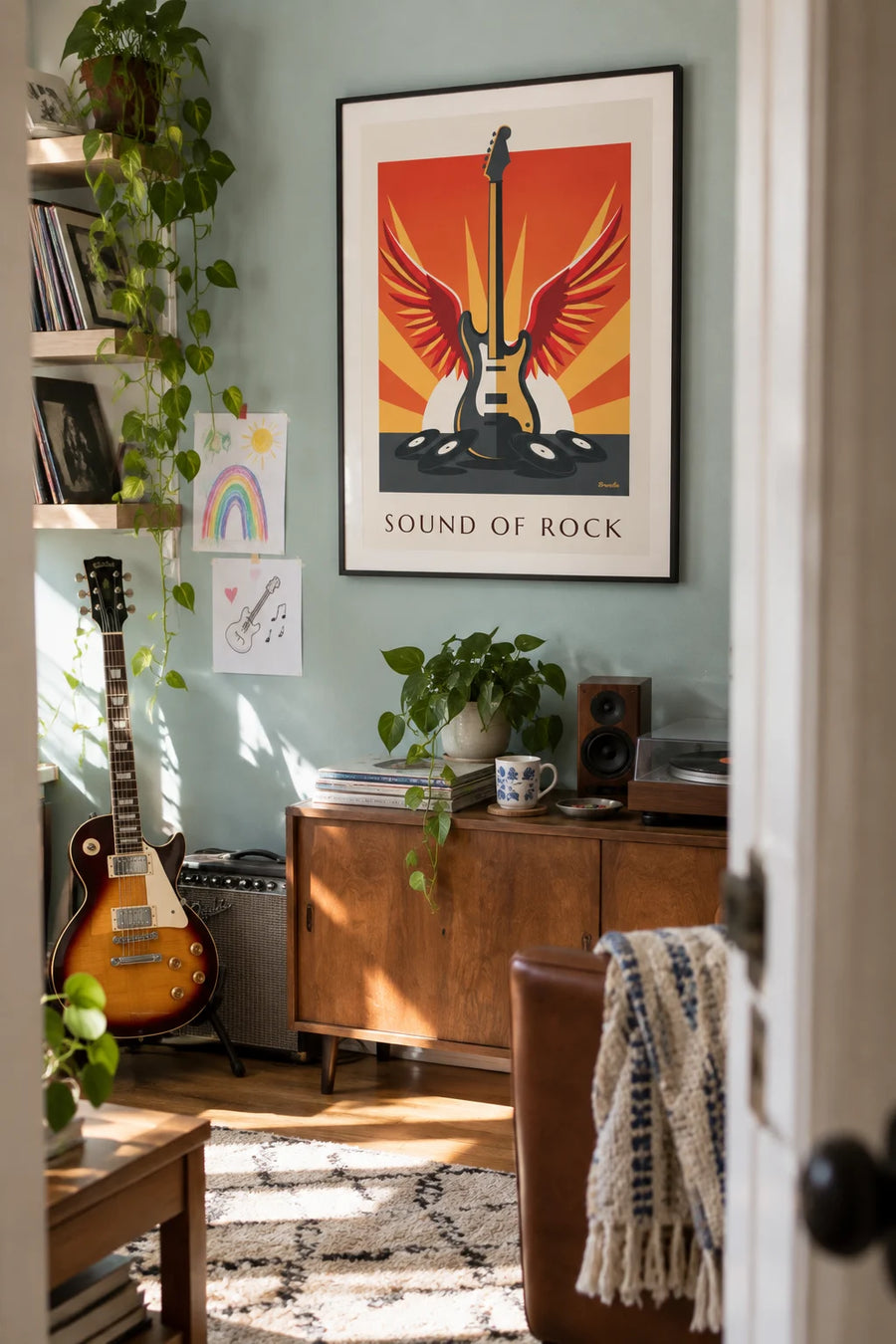 Poster of a winged electric guitar and vinyl records: framed on the wall