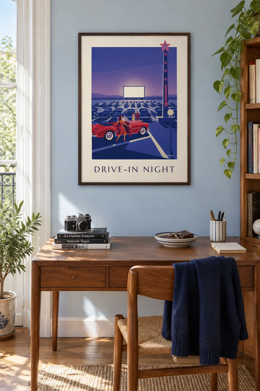 Pin-up and red convertible poster at an outdoor cinema: framed on the wall