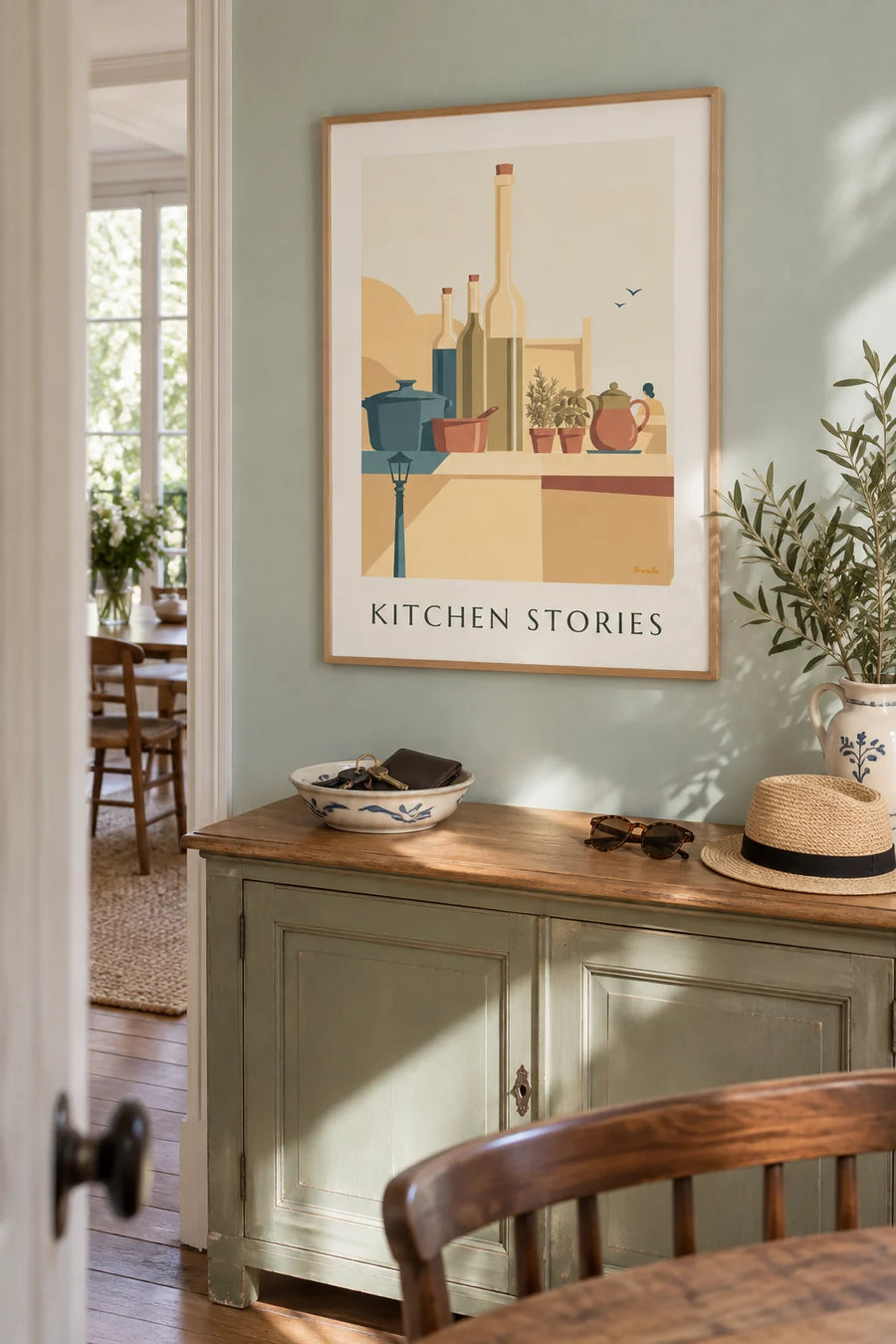 Poster of saucepans, painted teapots and kitchen bottles: framed on the wall