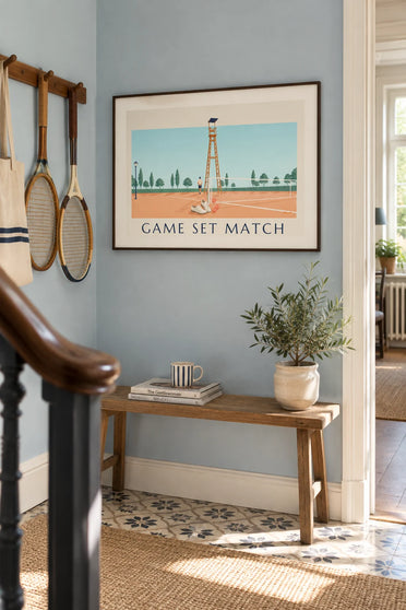 Poster of white tennis shoes and balls on a clay court: framed on the wall