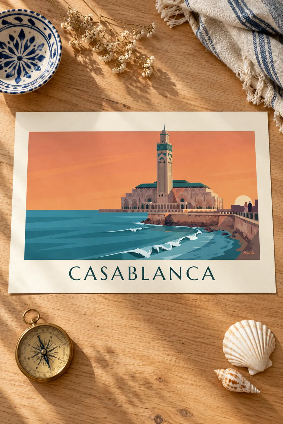 Poster of the Hassan II Mosque facing the ocean at sunset: set on a table